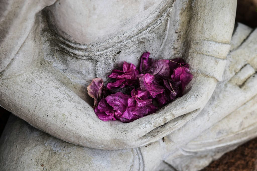 Shamanic healing - statue with flowers